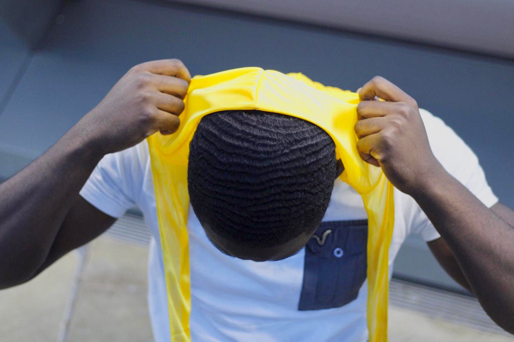 Starting your wave journey! Man pulling back silky durag to reveal 360 waves underneath